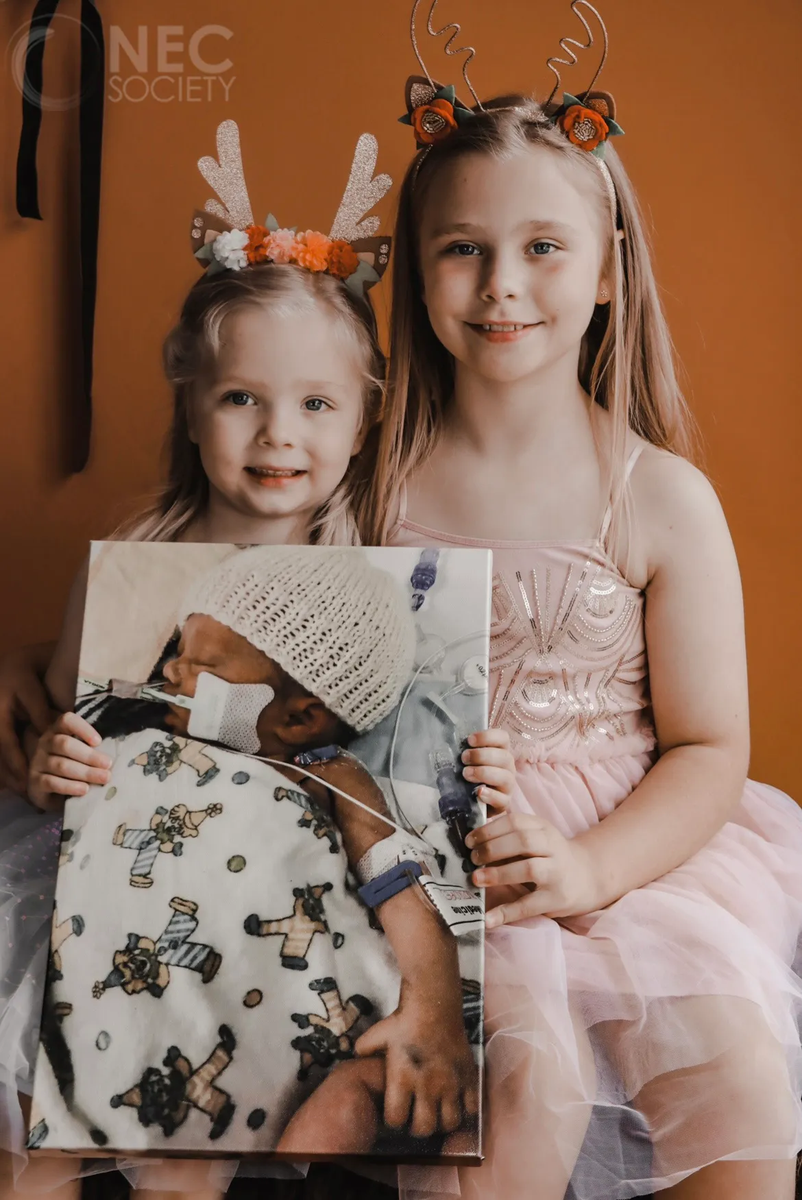 Avah and Charlotte holding a picture of Matilda