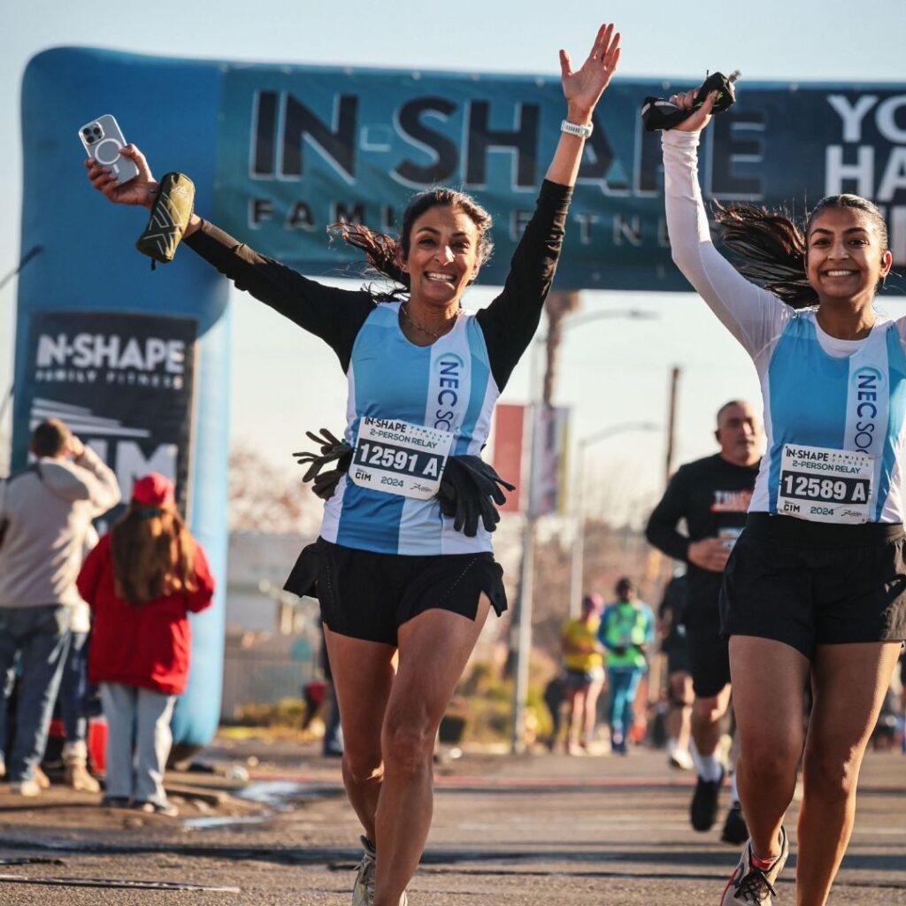 Women running a relay race together for a world without NEC