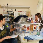 Jenn and Noah reading to Micah