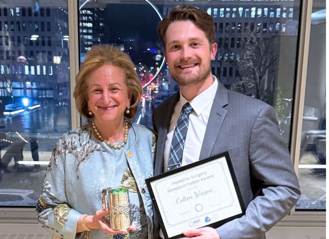 Colton Wayne and Gail Besner with award
