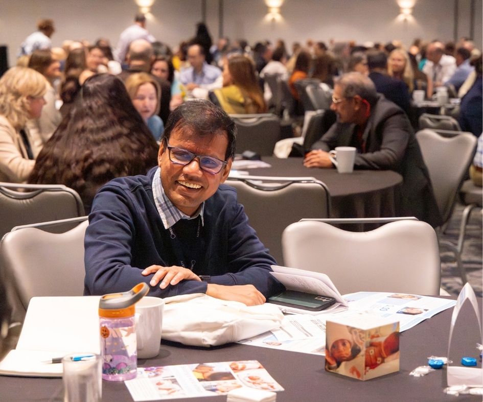 man smiling at table