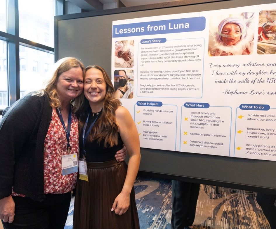 Women in front of a patient-family poster