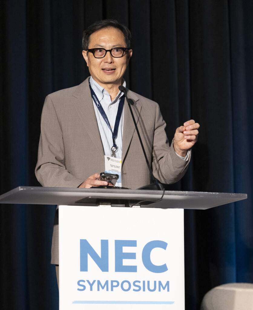 man presenting at NEC Symposium