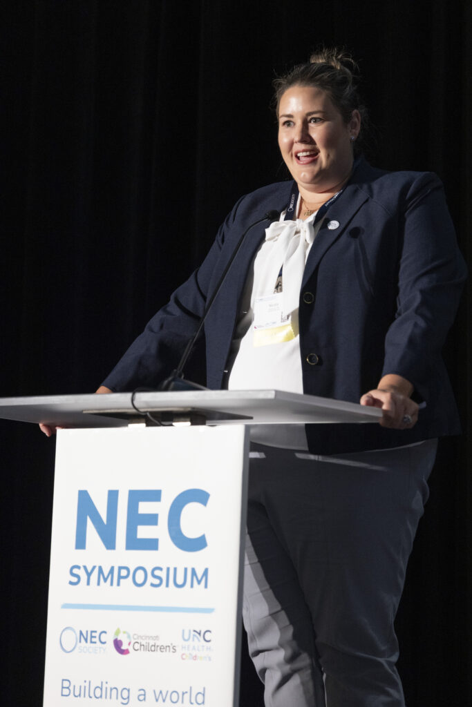 woman presenting at the NEC Symposium